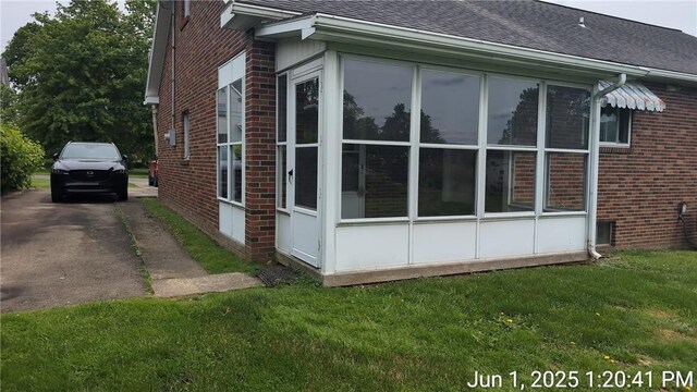 175 Sherman Ave, Waynsbrg/Frankln Twp, PA 15370 - view of side of property with brick siding, driveway, a shingled roof, and a lawn