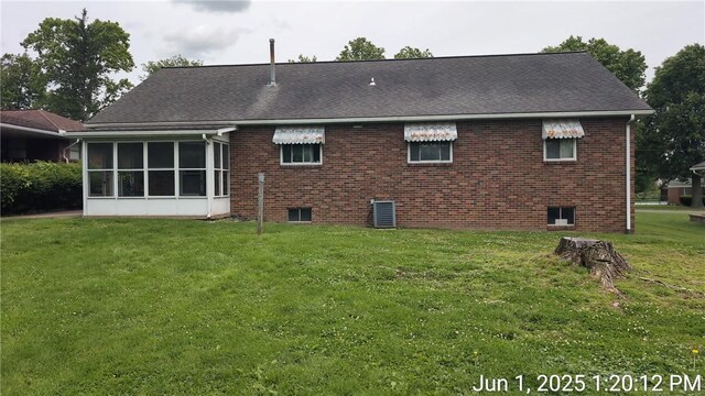 175 Sherman Ave, Waynsbrg/Frankln Twp, PA 15370 - back of property with a lawn, central AC unit, a sunroom, and brick siding