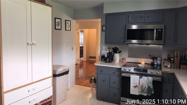 175 Sherman Ave, Waynsbrg/Frankln Twp, PA 15370 - kitchen featuring stainless steel appliances, light floors, light countertops, gray cabinets, and tile walls