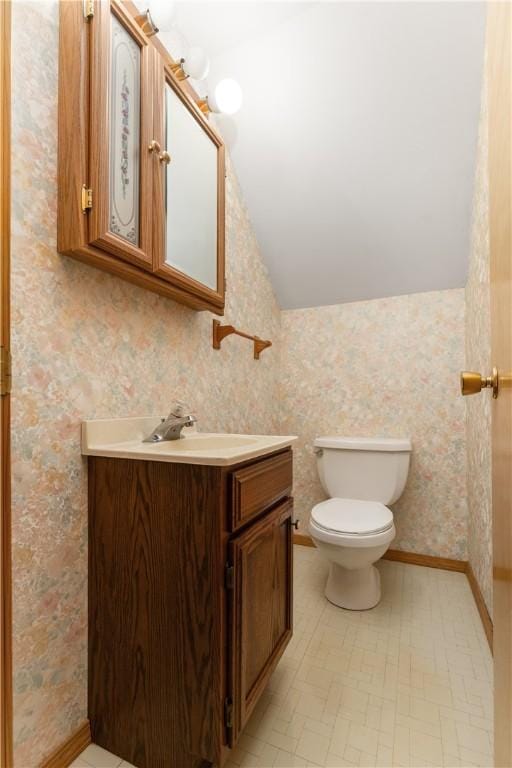 207 Mccartney Dr, Moon/Crescent Twp, PA 15108 - bathroom with vanity, lofted ceiling, toilet, and wallpapered walls