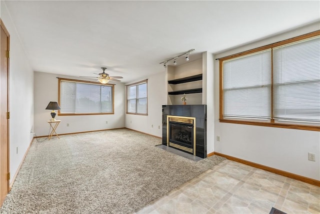 207 Mccartney Dr, Moon/Crescent Twp, PA 15108 - unfurnished living room featuring a tile fireplace, ceiling fan, track lighting, and baseboards