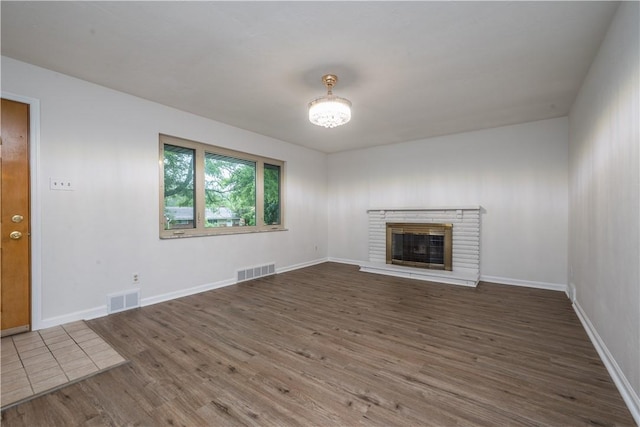 126 Woodhall Dr, Baldwin Boro, PA 15236 - unfurnished living room featuring wood finished floors, a brick fireplace, baseboards, and a chandelier