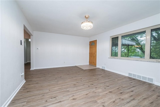 126 Woodhall Dr, Baldwin Boro, PA 15236 - unfurnished room with wood finished floors, baseboards, and a chandelier
