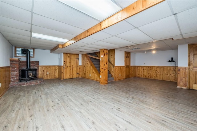 126 Woodhall Dr, Baldwin Boro, PA 15236 - finished basement featuring wainscoting, a paneled ceiling, wood walls, wood finished floors, and a wood stove