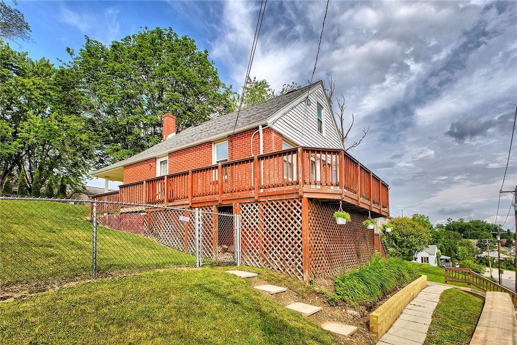 224 S Lincoln Ave, Hempfield Twp Wml, PA 15601 - view of side of home featuring brick siding, a wooden deck, and a chimney