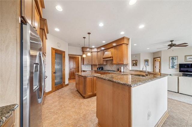 127 Chelsea Dr, Unity Twp, PA 15650 - kitchen with stainless steel appliances, premium range hood, open floor plan, a sink, and dark stone counters
