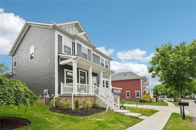 1213 Newbury Highland, South Fayette, PA 15017 - view of front of house with covered porch, a front lawn, and board and batten siding