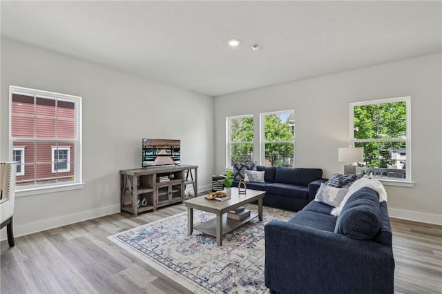 1213 Newbury Highland, South Fayette, PA 15017 - living area with healthy amount of natural light, wood finished floors, baseboards, and recessed lighting
