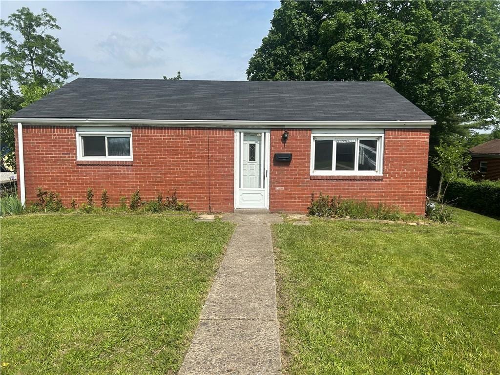 733 Memory Ln, Liberty Boro, PA 15133 - view of front facade featuring brick siding, a front yard, and a shingled roof