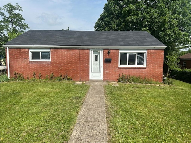 733 Memory Ln, Liberty Boro, PA 15133 - view of front facade featuring brick siding, a front yard, and a shingled roof