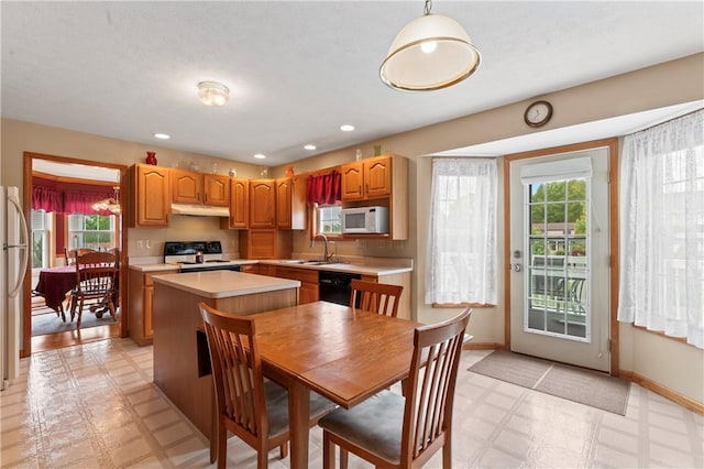 115 Lawrence Dr, Brighton Twp, PA 15009 - kitchen featuring white microwave, range, light floors, healthy amount of natural light, and recessed lighting