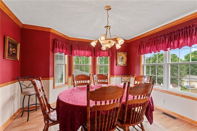 115 Lawrence Dr, Brighton Twp, PA 15009 - dining room featuring a chandelier, light wood-style flooring, crown molding, and baseboards