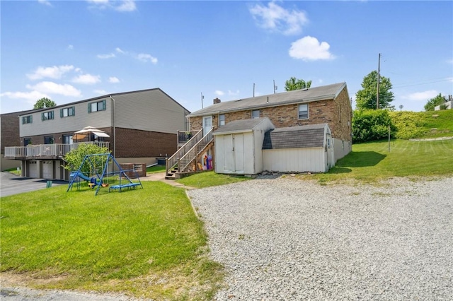 1230 Frank Ave, Jeannette, PA 15644 - view of front of home with stairway, a front yard, and a garage