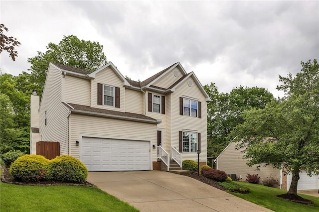 929 White Water, Adams Twp, PA 16046 - traditional home with concrete driveway, a garage, cooling unit, and a front lawn