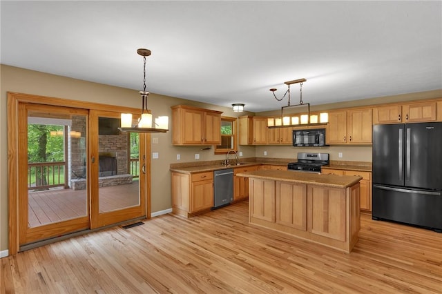 929 White Water, Adams Twp, PA 16046 - kitchen featuring black appliances, a sink, light wood-type flooring, light brown cabinets, and a center island