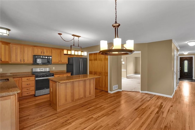 929 White Water, Adams Twp, PA 16046 - kitchen with black appliances, a kitchen island, light wood-style floors, hanging light fixtures, and crown molding