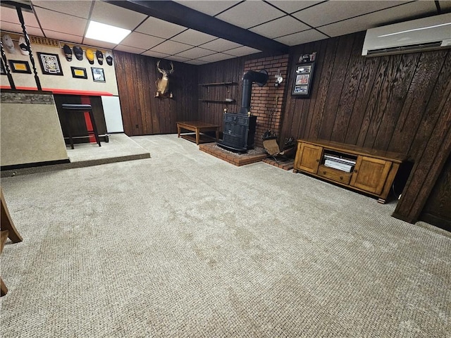 261 Lacock St, Canton Twp, PA 15301 - cinema room featuring a wood stove, carpet flooring, a paneled ceiling, a wall mounted AC, and wood walls