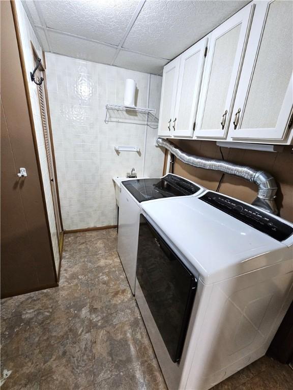 261 Lacock St, Canton Twp, PA 15301 - laundry area featuring cabinet space, separate washer and dryer, and stone finish flooring