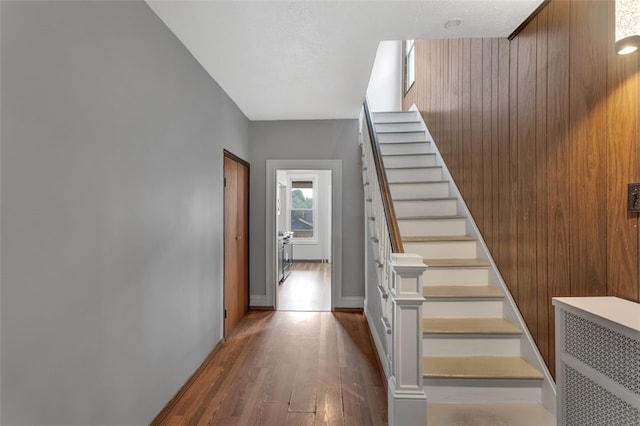 901 Punta Gorda Ave, East Mckeesport, PA 15035 - staircase featuring hardwood / wood-style floors and wooden walls