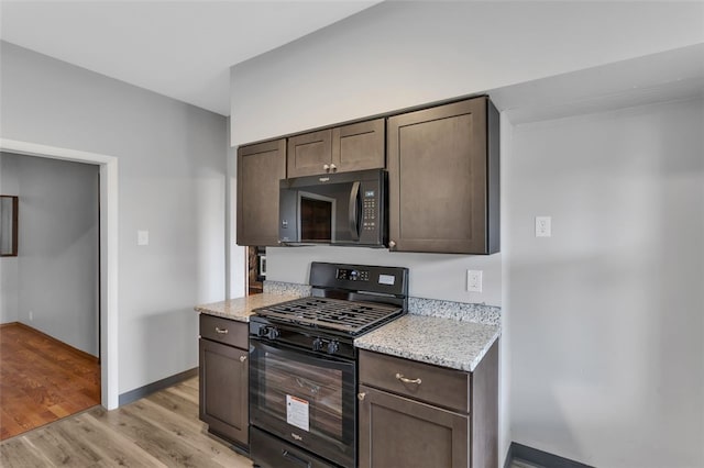 901 Punta Gorda Ave, East Mckeesport, PA 15035 - kitchen featuring black appliances, dark brown cabinets, light wood finished floors, and baseboards