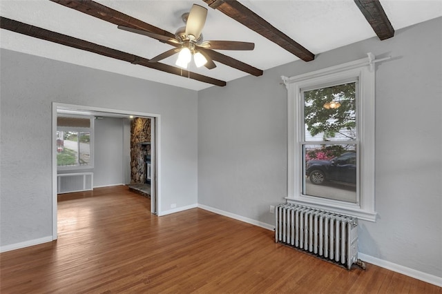 901 Punta Gorda Ave, East Mckeesport, PA 15035 - unfurnished room with radiator heating unit, beamed ceiling, plenty of natural light, wood finished floors, and ceiling fan
