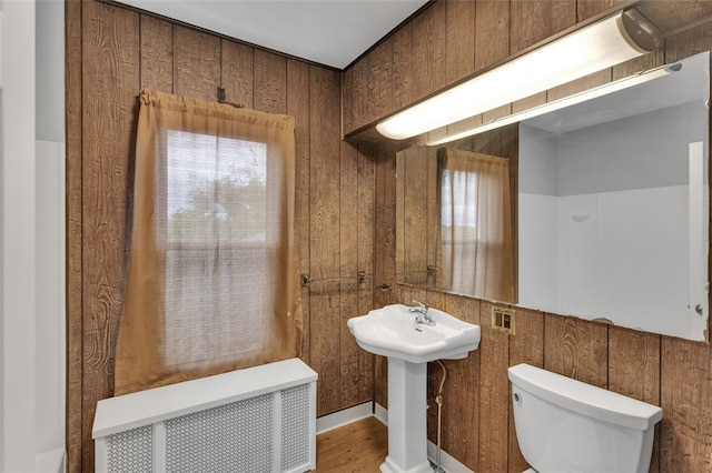 901 Punta Gorda Ave, East Mckeesport, PA 15035 - bathroom featuring toilet, radiator, healthy amount of natural light, wood finished floors, and wood walls