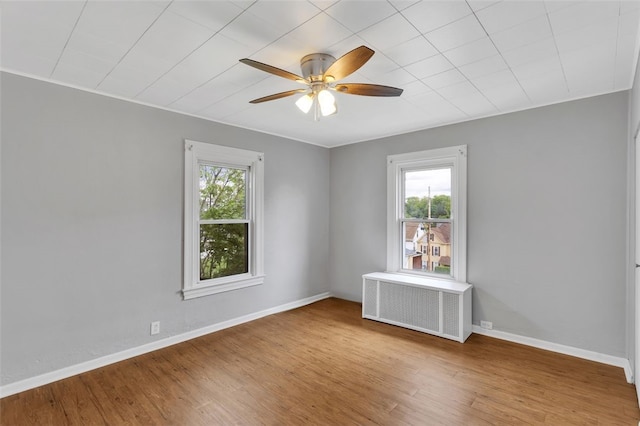 901 Punta Gorda Ave, East Mckeesport, PA 15035 - unfurnished room with radiator, a ceiling fan, wood finished floors, and baseboards