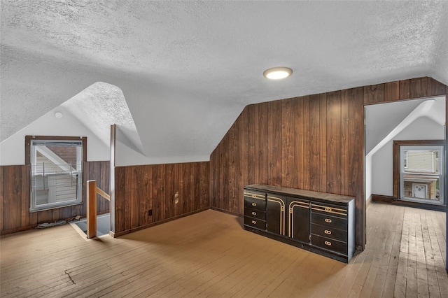 901 Punta Gorda Ave, East Mckeesport, PA 15035 - bonus room featuring a textured ceiling, wooden walls, vaulted ceiling, and wood-type flooring