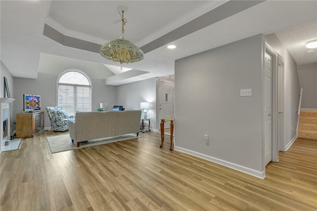 127 Crosswynds Unit 127, Chippewa Twp, PA 15010 - living area with baseboards, light wood-style floors, a raised ceiling, a chandelier, and stairs