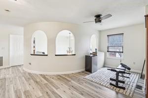 412 Rose Dr, Cranberry Twp, PA 16066 - unfurnished living room featuring ceiling fan, wood finished floors, and baseboards