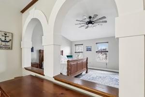 412 Rose Dr, Cranberry Twp, PA 16066 - hall featuring vaulted ceiling, arched walkways, and wood finished floors