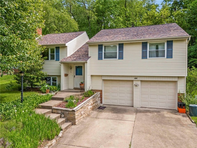344 Fruitwood Dr, Bethel Park, PA 15102 - view of front facade featuring a garage, driveway, a shingled roof, and a chimney