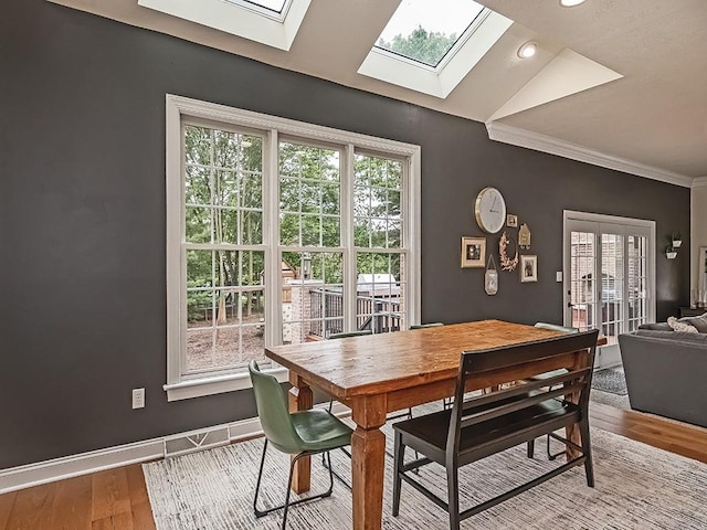 906 Big Bear Ct, Adams Twp, PA 15044 - dining room featuring a skylight, healthy amount of natural light, wood finished floors, ornamental molding, and baseboards