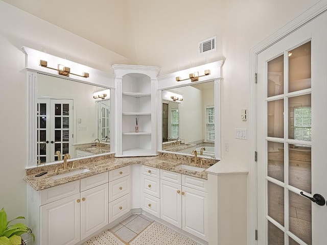 906 Big Bear Ct, Adams Twp, PA 15044 - bathroom featuring french doors, double vanity, and tile patterned flooring