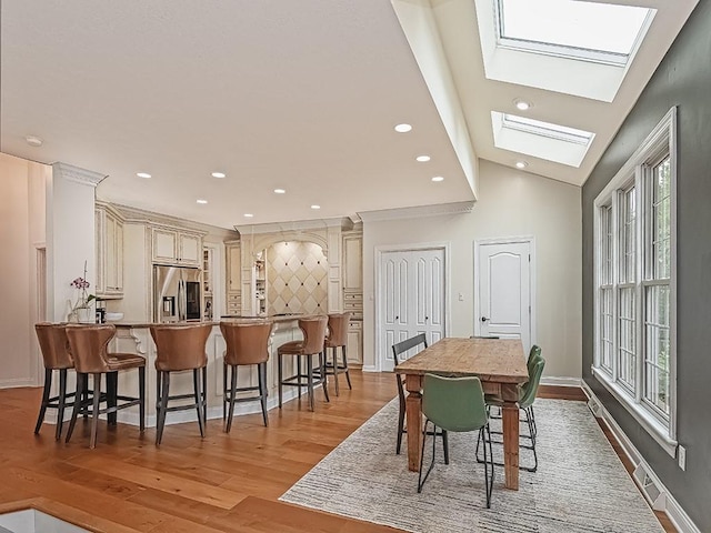 906 Big Bear Ct, Adams Twp, PA 15044 - dining area featuring light wood-style flooring, a skylight, recessed lighting, baseboards, and lofted ceiling