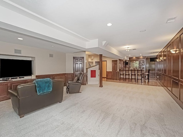 906 Big Bear Ct, Adams Twp, PA 15044 - living room with bar area, a wainscoted wall, light colored carpet, recessed lighting, and a decorative wall