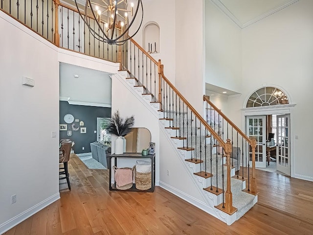 906 Big Bear Ct, Adams Twp, PA 15044 - staircase featuring a high ceiling, hardwood / wood-style flooring, baseboards, crown molding, and a chandelier