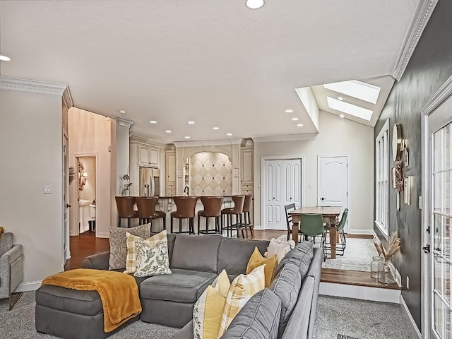 906 Big Bear Ct, Adams Twp, PA 15044 - living room featuring baseboards, recessed lighting, a skylight, vaulted ceiling, and ornamental molding