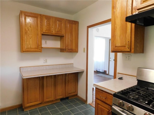 2300 Fairland St, Overbrook, PA 15210 - kitchen featuring stainless steel gas range oven, under cabinet range hood, light countertops, and baseboards