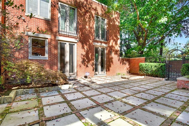 222 Schenley Rd, Squirrel Hill, PA 15217 - rear view of house with brick siding, a patio area, and a gate