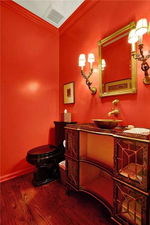 222 Schenley Rd, Squirrel Hill, PA 15217 - bathroom featuring wood finished floors, vanity, toilet, and crown molding