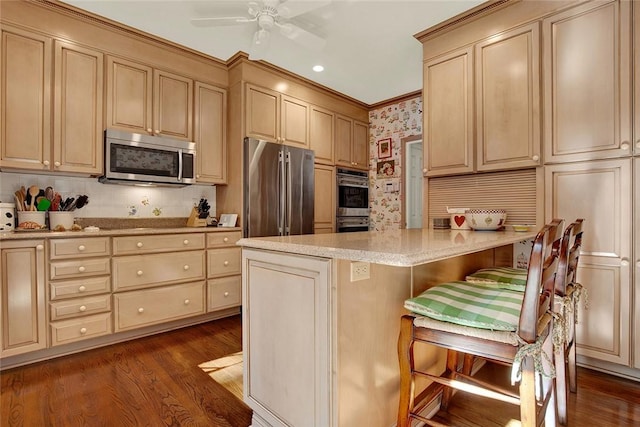 222 Schenley Rd, Squirrel Hill, PA 15217 - kitchen featuring appliances with stainless steel finishes, dark wood-style floors, a breakfast bar, a peninsula, and crown molding