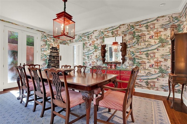 222 Schenley Rd, Squirrel Hill, PA 15217 - dining space with wallpapered walls, baseboards, wood finished floors, crown molding, and a chandelier
