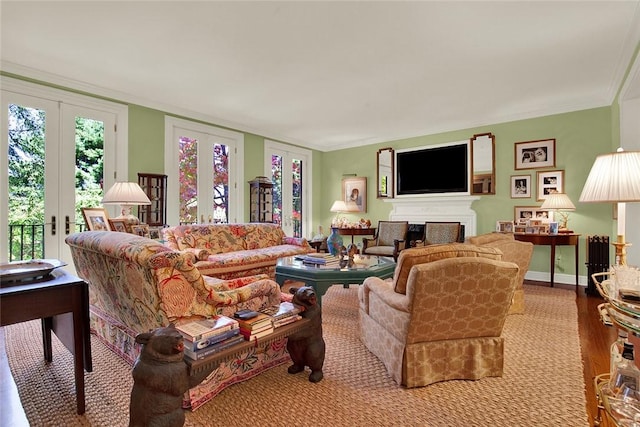 222 Schenley Rd, Squirrel Hill, PA 15217 - living area with ornamental molding, wood finished floors, a fireplace, baseboards, and french doors