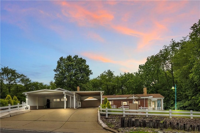 427 Harpers Ferry Rd, North Sewickley Twp, PA 15010 - view of home's community with a fenced front yard, driveway, an attached carport, and view of wooded area