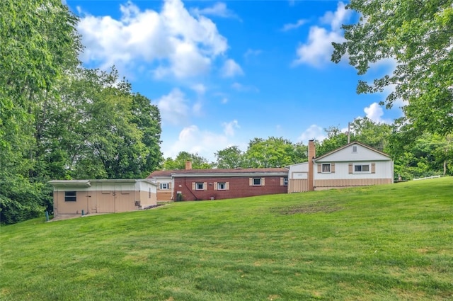 427 Harpers Ferry Rd, North Sewickley Twp, PA 15010 - back of house with a chimney, a yard, view of scattered trees, and brick siding