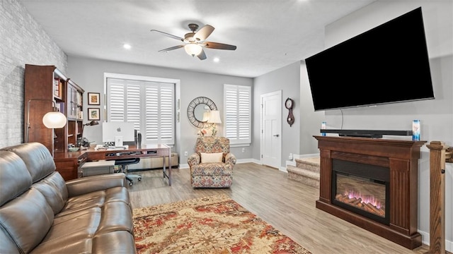 155 Bucktail Dr, Cranberry Twp, PA 16066 - living area with ceiling fan, wood finished floors, an office area, a glass covered fireplace, and baseboards