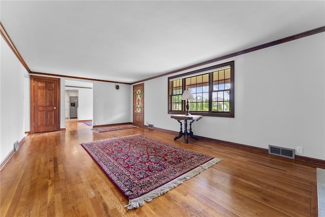221 Moody Rd, Imperial, PA 15126 - unfurnished living room featuring crown molding, wood finished floors, and baseboards