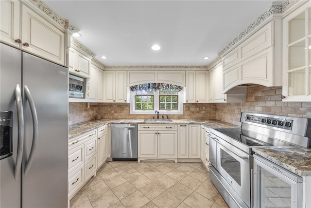 221 Moody Rd, Imperial, PA 15126 - kitchen with appliances with stainless steel finishes, a sink, decorative backsplash, light stone counters, and glass insert cabinets