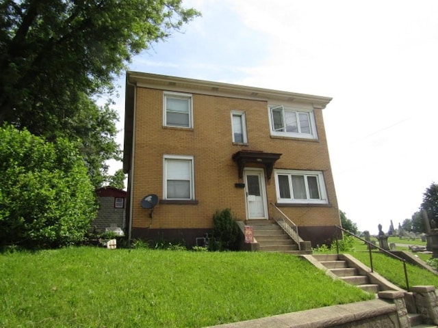 2445 Brownsville Rd, Carrick, PA 15210 - view of front of home with brick siding, a front lawn, and entry steps